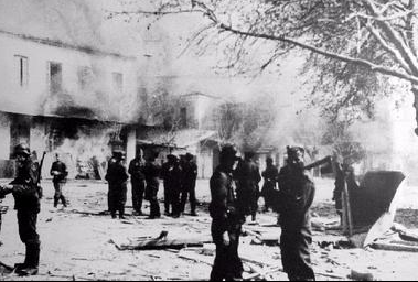 German troops in front of buildings set ablaze in Distomo, during the massacre.